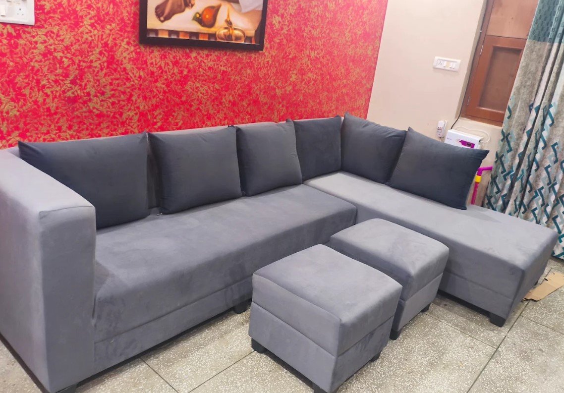 Completed grey L-shaped sofa with matching ottomans