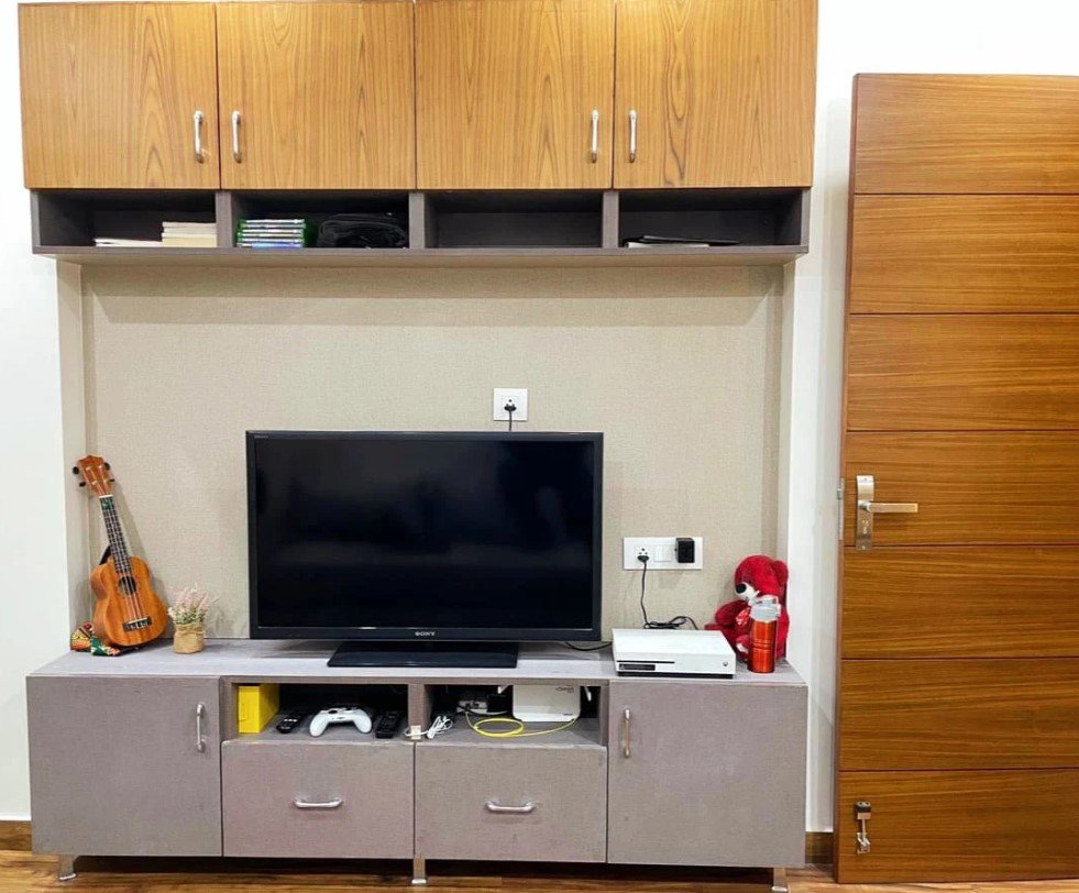 Completed TV cabinet with overhead cupboards and entertainment storage