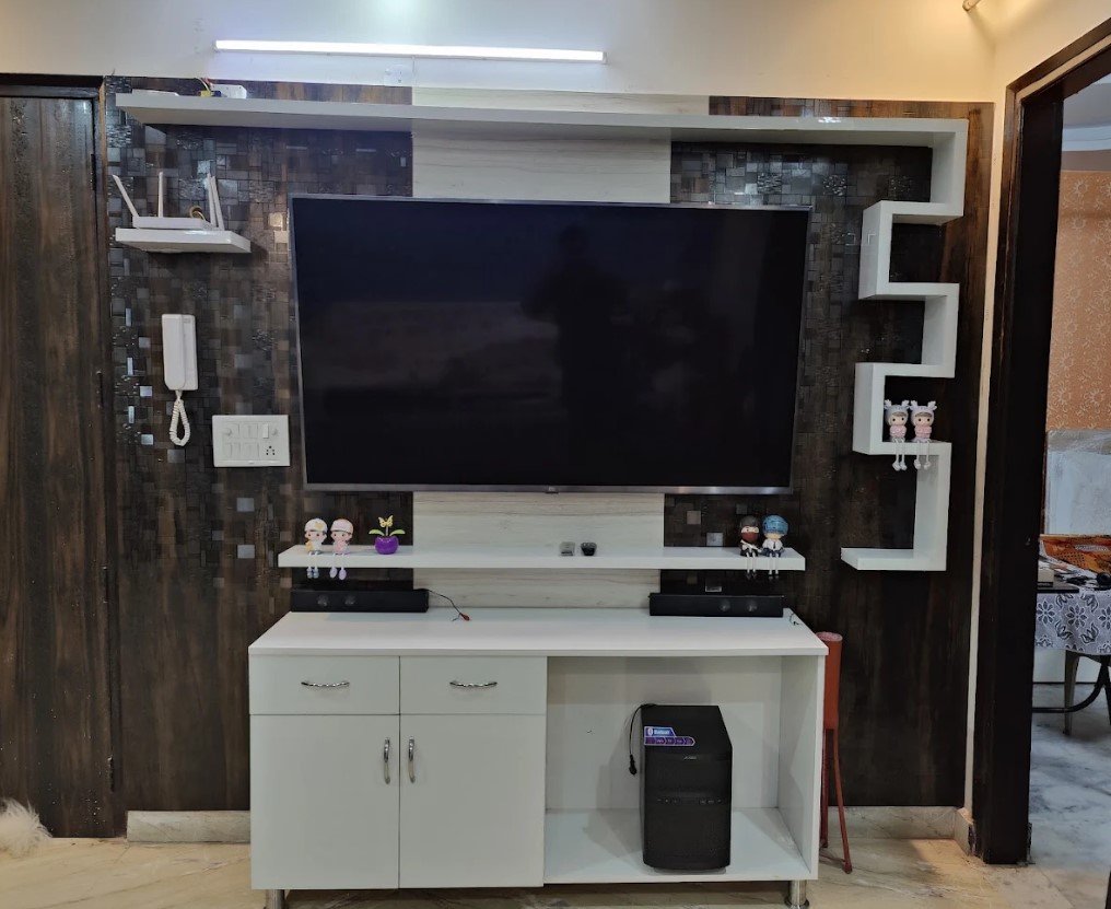 Completed modern TV console with contrasting wall panels and storage